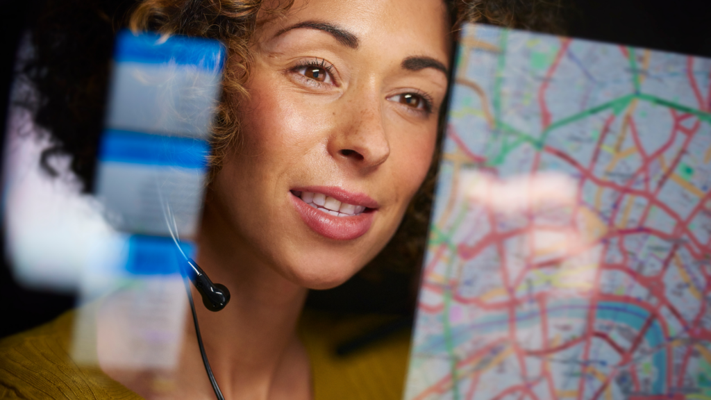 Freight broker monitoring routes and logistics on-screen to ensure seamless shipment coordination.