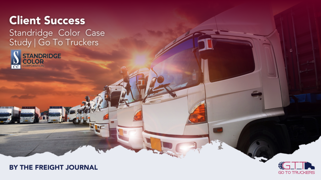 Fleet of white trucks at sunset representing Go To Truckers’ logistics partnership with Standridge Color.